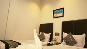 Postel nebo postele na pokoji v ubytování Sunrise Hotel Jombor Jogja