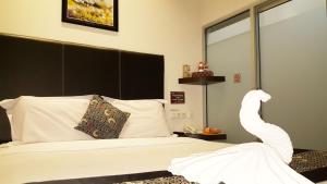 Postel nebo postele na pokoji v ubytování Sunrise Hotel Jombor Jogja