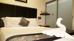 Postel nebo postele na pokoji v ubytování Sunrise Hotel Jombor Jogja
