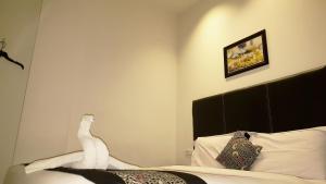 Postel nebo postele na pokoji v ubytování Sunrise Hotel Jombor Jogja