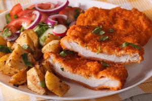 a plate of food with fish and potatoes and a salad at Imperial Hotel Coonabarabran in Coonabarabran