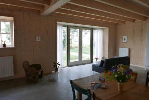 a living room with a table and a couch at VierVaart Studio appartement in Groede