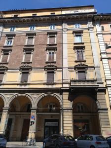 ein großes Gebäude mit davor geparkt in der Unterkunft Miro' Holiday Attic in Bologna