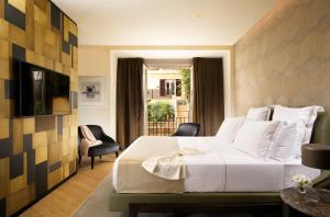 Margutta 19 - Small Luxury Hotels of the World tesisinde bir odada yatak veya yataklar