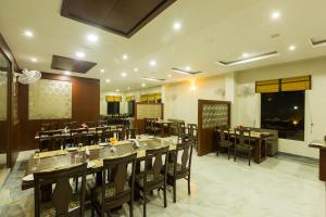 a restaurant with tables and chairs in a room at Mount Valley Resort in Kumbhalgarh
