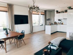 a living room with a table and a kitchen at AVLiving City LOFT Basel in Basel