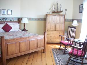 A bed or beds in a room at Louisbourg Harbour Inn