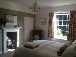 
a bedroom with a bed and a fireplace at Mill House Bed and Breakfast in Cromer
