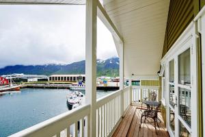 a balcony of a house with a boat in the water at Siglo Hotel by Keahotels in Siglufjörður