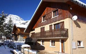 a building with a balcony on the side of it at Chalet Alpina in Les Deux Alpes