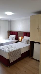 Postel nebo postele na pokoji v ubytování Laleli Hotel Izmir