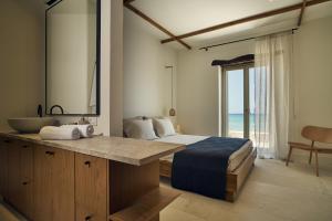 A bed or beds in a room at Niova Villa - Seafront, private pool and Ionian Sea Views, by ZanteWize