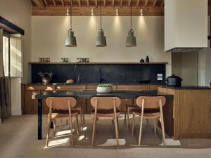 a kitchen with a table and chairs in a room at Niova Villa in Alykes