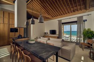 A television and/or entertainment centre at Niova Villa - Seafront, private pool and Ionian Sea Views, by ZanteWize