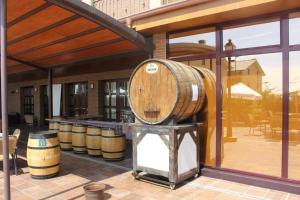 a large wooden barrel sitting outside of a building at Hostal Casa Perico in Larraga