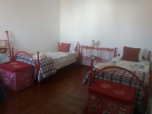 a room with two twin beds in a room at Apartamento Rosa in Vila Nova de Milfontes