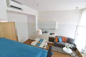 a living room with a bed and a couch at The Bridge Luxury Apartments in Zadar