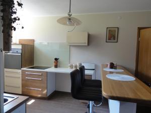 a kitchen with a table and a chair in it at Apartma Jezero in Most na Soči