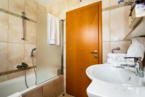a bathroom with a sink and a shower at Mare & Mons Seafront Apartments in Malinska +79 photos