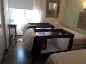 szereg łóżek w pokoju z oknem w obiekcie The Central Suites w Nikozji