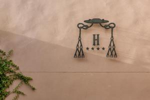 a clock on the side of a building at Hotel Ca'l Bisbe in Sóller