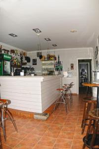 a bar in a restaurant with tables and chairs at Hotel Rural Isasi in Gordexola