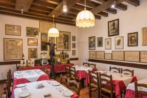 a dining room with tables and chairs and pictures on the walls at Hotel San Marco in Montebelluna