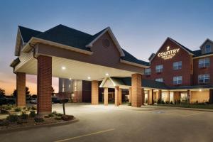 a hotel with a parking lot in front of it at Country Inn & Suites by Radisson, Coralville, IA in Coralville