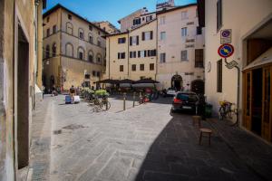 a city street with buildings and people on bikes at Casa Laura in Florence