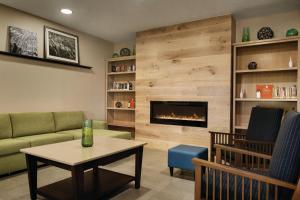 a living room with a couch and a fireplace at Country Inn & Suites by Radisson, Coralville, IA in Coralville