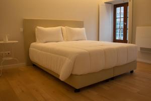 Postel nebo postele na pokoji v ubytování Feira Hostel & Suites