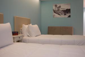 Postel nebo postele na pokoji v ubytování Feira Hostel & Suites
