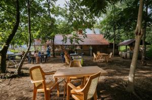 a group of tables and chairs in a yard at Hotel Forest Fairy in Shekvetili