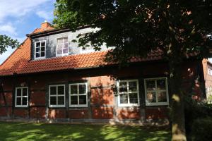 an old brick house with a red roof at Mühlengasthof Landesbergen in Landesbergen