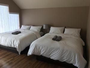 two beds sitting next to each other in a bedroom at Emperial Suites in North Vancouver