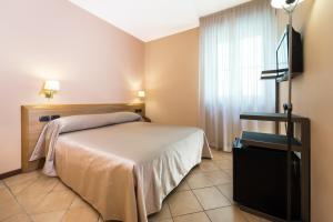 Postel nebo postele na pokoji v ubytování Hotel Bernardino