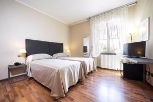 Postel nebo postele na pokoji v ubytování Hotel Bernardino