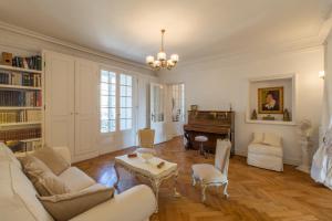 a living room with a couch and a piano at Penthouse Lou Lòu by iVillamia com in Nice