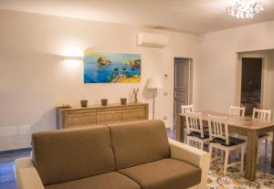 a living room with a couch and a table at VILLA MARYLU' in Ischia Town