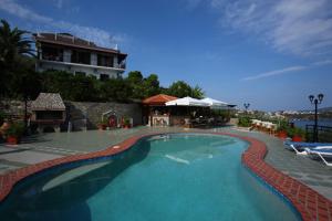 a large swimming pool in front of a building at Villa Melia in Vassilias