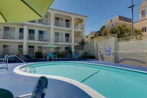 a swimming pool in front of a hotel at Vagabond Inn San Pedro in San Pedro