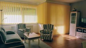 a living room with two chairs and a couch and a table at Pinewood Valley Oasis in Vyšné Ružbachy