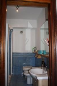 a bathroom with two toilets and a sink and a mirror at Patrancarro Home - Letojanni Taormina in Letojanni +37 photos
