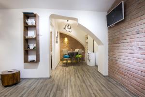 a hallway with a brick wall and a dining room at Apartman Vita in Zagreb