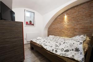 Un pat sau paturi într-o cameră la Apartman Vita