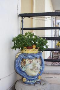a statue of a face with a plant in it at Patrancarro Home - Letojanni Taormina in Letojanni