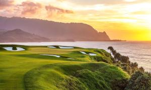 a golf course with the ocean in the background at 1 Hotel Hanalei Bay in Princeville