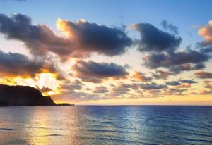a sunset over the ocean with clouds at 1 Hotel Hanalei Bay in Princeville