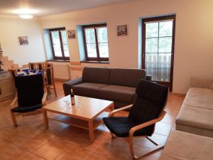 a living room with a couch and a coffee table at Lipnoapartments 88 in Lipno nad Vltavou
