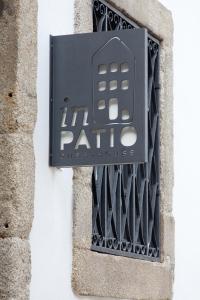 a sign on the side of a building at InPatio Guest House in Porto